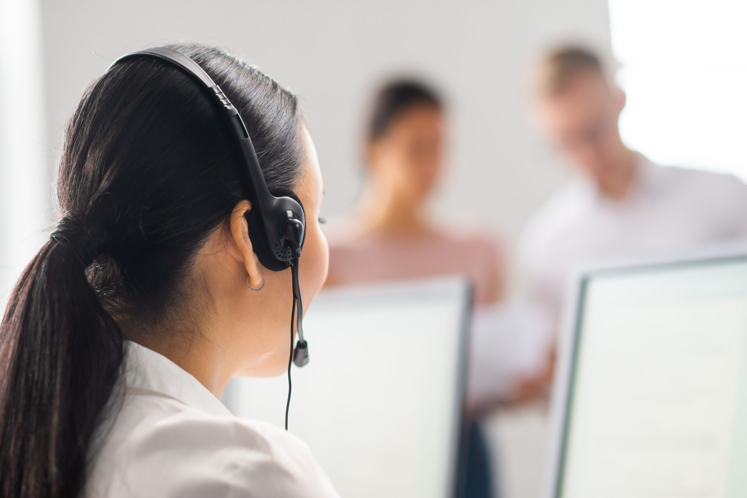 Diverse team of young professionals is working in the phone support office. Working day of sales managers in the call center. Concept of business, telephone consulting and problem solving.